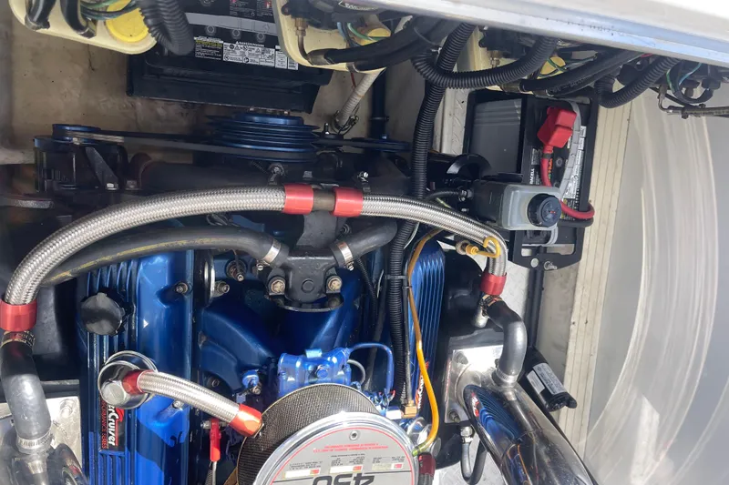 Slide: The Image of Engine compartment of a 1995 Excel Scarab 43 boat, showcasing detailed components. - 34