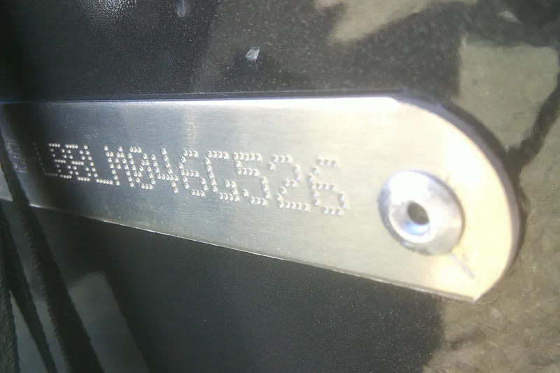Slide: The Image of Close-up of a metal plate with engraved serial number on a 2026 Lund 1775 Adventure Sport. - 19