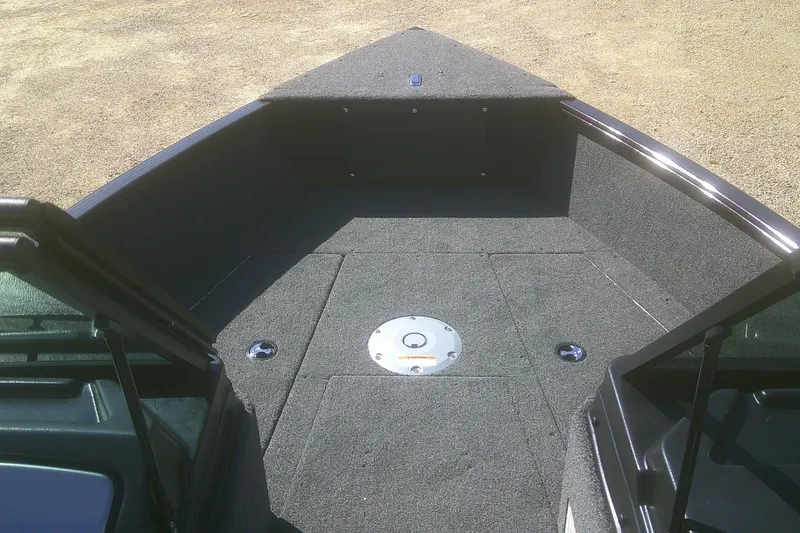 Slide: The Image of 2026 Lund 1775 Adventure Sport boat interior with carpeted deck and storage compartments. - 3