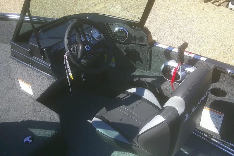 Slide: The Image of 2026 Lund 1775 Adventure Sport boat interior with steering wheel and control panel. - 9