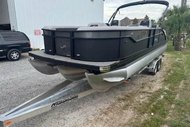 Slide: The Image of 2026 Barletta ARIA 24 UC pontoon boat on trailer, parked outdoors. - 9