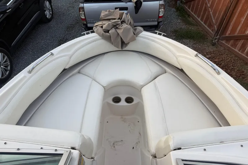Slide: The Image of 2002 Maxum 1900 SR boat interior with white seating and cup holders. - 10