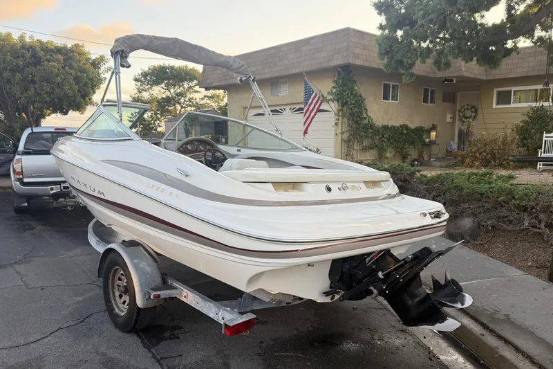 Slide: The Image of 2002 Maxum 1900 SR boat on trailer in residential driveway. - 2
