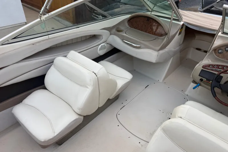 Slide: The Image of 2002 Maxum 1900 SR boat interior with white seating and dashboard. - 8