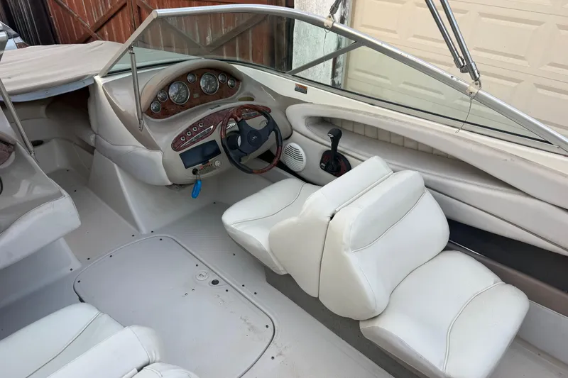 Slide: The Image of 2002 Maxum 1900 SR boat interior with white seats and dashboard controls. - 9