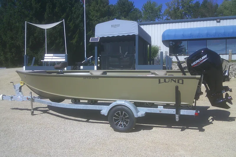 The Image of 2026 Lund 1875 Alaskan Tiller boat on trailer with Mercury outboard motor. - 1