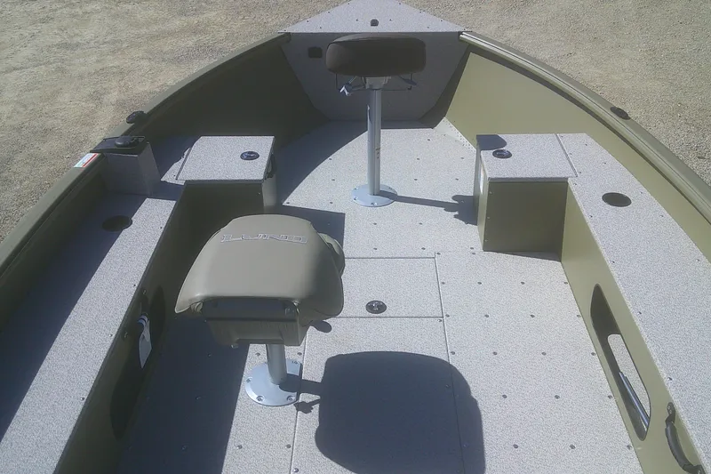 Slide: The Image of 2026 Lund 1875 Alaskan Tiller boat interior with seating and storage compartments. - 3