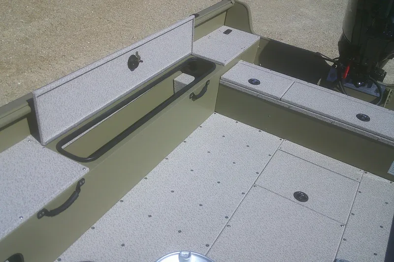 Slide: The Image of 2026 Lund 1875 Alaskan Tiller boat interior with storage compartments and motor. - 8