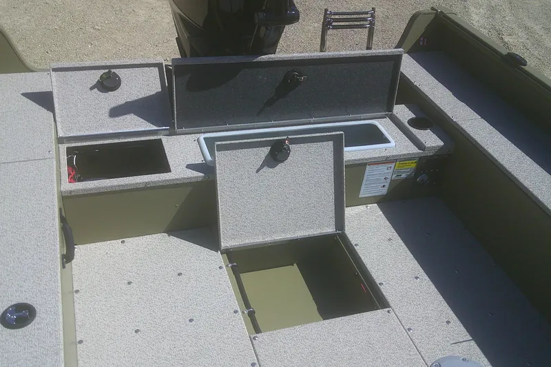 Slide: The Image of 2026 Lund 1875 Alaskan Tiller boat interior with open storage compartments. - 9