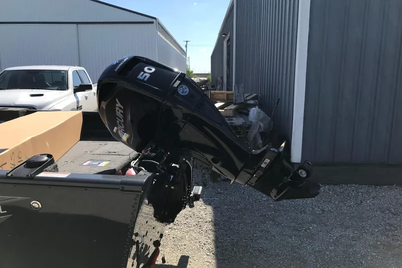 Slide: The Image of 2026 Lund 1650 Rebel XL SS boat interior with storage compartments and cup holders. - 10