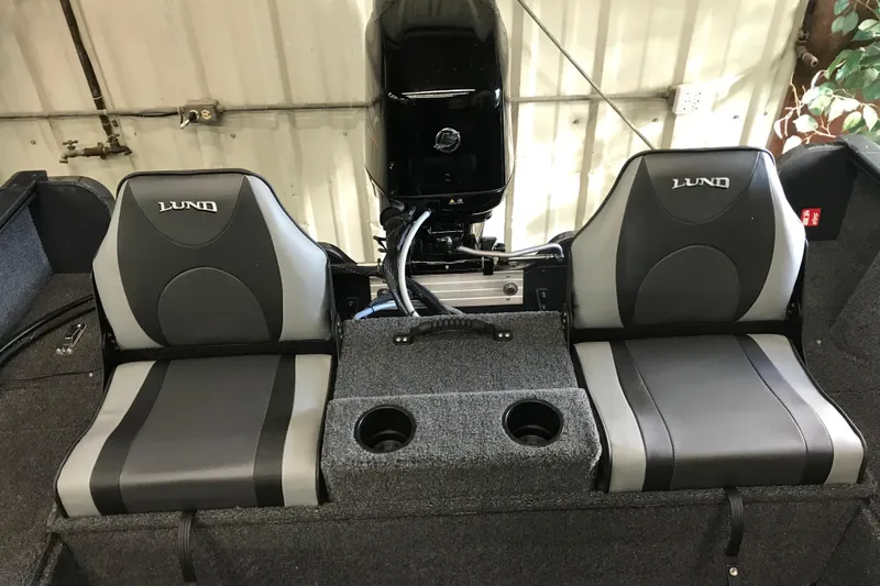 Slide: The Image of 2026 Lund 1650 Rebel XL SS boat seats with cup holders, featuring sleek design. - 11