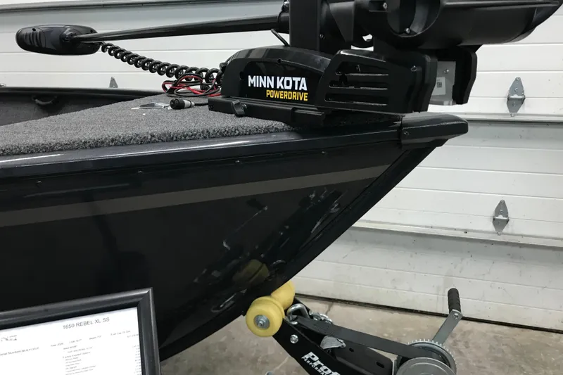 Slide: The Image of 2026 Lund 1650 Rebel XL SS boat with Minn Kota PowerDrive motor in garage. - 4