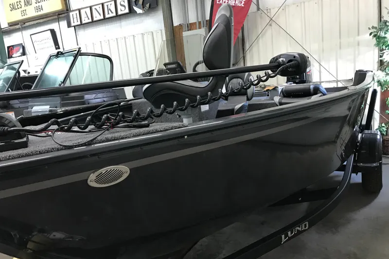 Slide: The Image of 2026 Lund 1650 Rebel XL SS boat in showroom, featuring sleek design and modern equipment. - 5