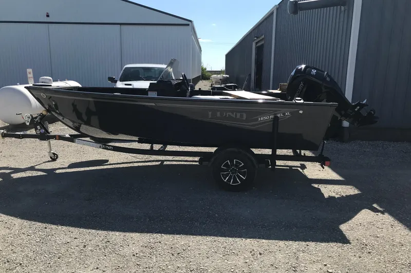 Slide: The Image of 2026 Lund 1650 Rebel XL SS boat interior with seating and Mercury engine. - 7