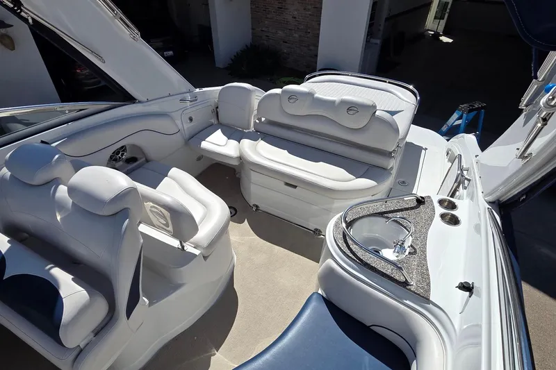 Slide: The Image of 2013 Crownline 325 SCR boat interior with plush seating and sleek design. - 11