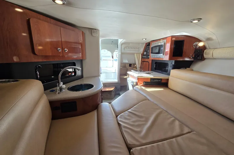 Slide: The Image of Luxurious interior of 2013 Crownline 325 SCR boat with kitchenette and seating area. - 22