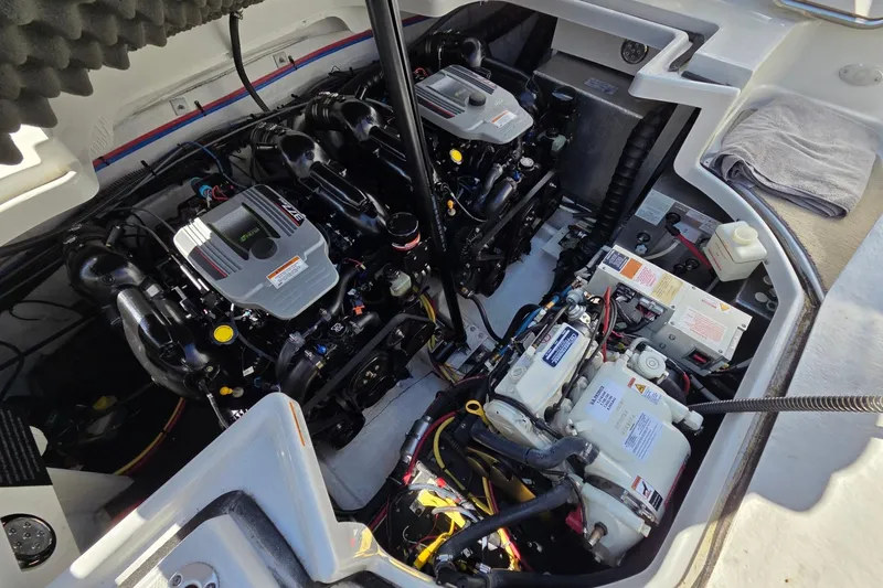 Slide: The Image of Engine compartment of a 2013 Crownline 325 SCR boat, showcasing dual engines and mechanical components. - 25