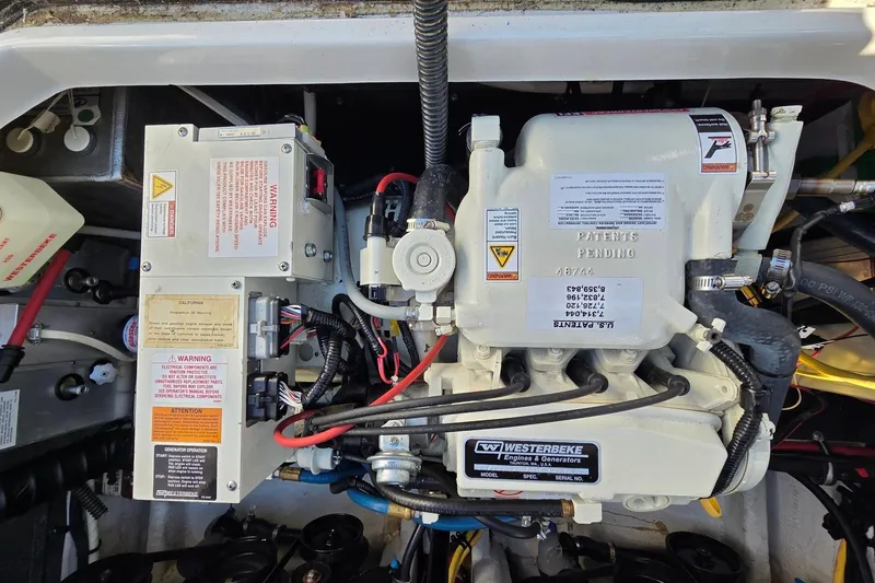 Slide: The Image of Engine compartment of a 2013 Crownline 325 SCR boat, featuring a Westerbeke generator. - 27