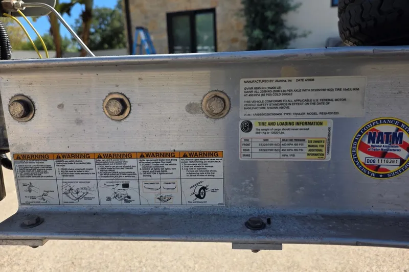 Slide: The Image of 2013 Crownline 325 SCR trailer warning labels and compliance stickers, close-up view. - 29