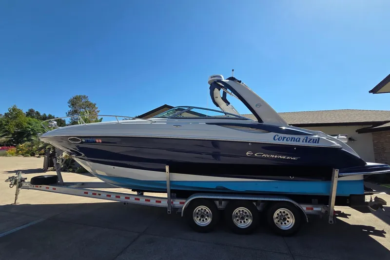 Slide: The Image of 2013 Crownline 325 SCR boat on trailer under clear blue sky. - 5