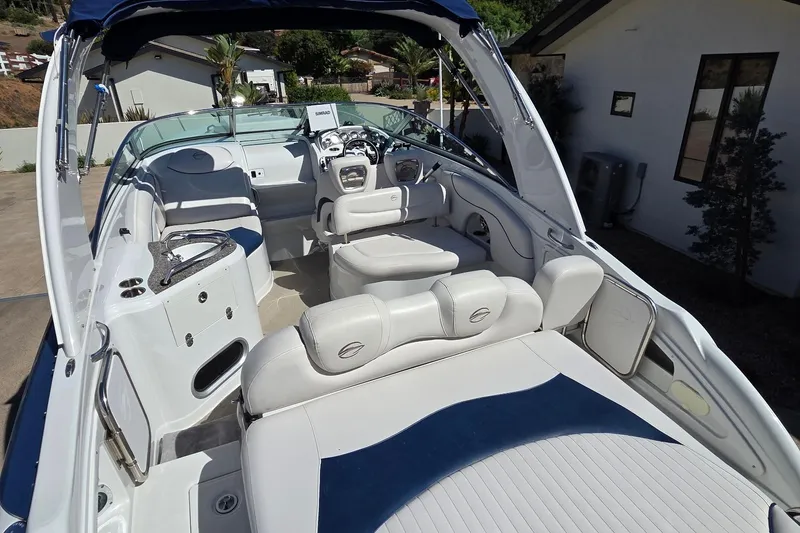 Slide: The Image of 2013 Crownline 325 SCR boat interior with white seating and modern dashboard. - 7