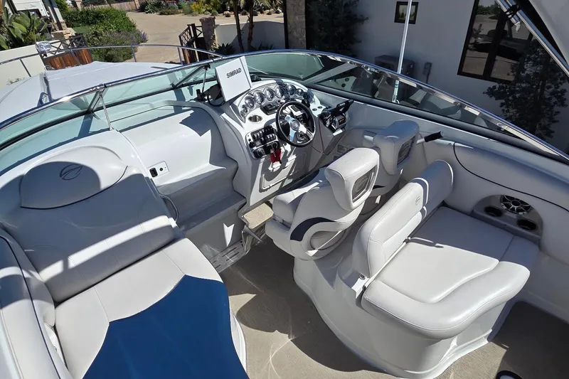 Slide: The Image of 2013 Crownline 325 SCR boat interior with modern helm and seating. - 8