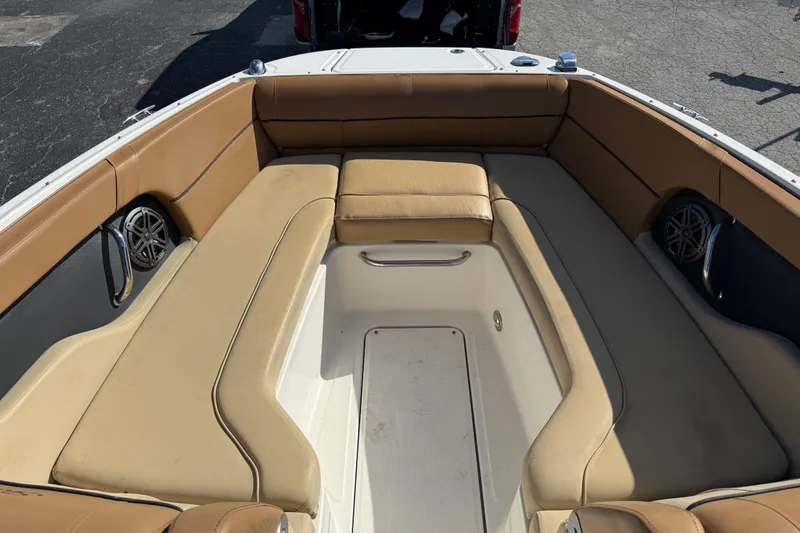 Slide: The Image of 2014 Sea Ray 240 Sundeck Outboard with spacious tan seating and built-in speakers. - 12