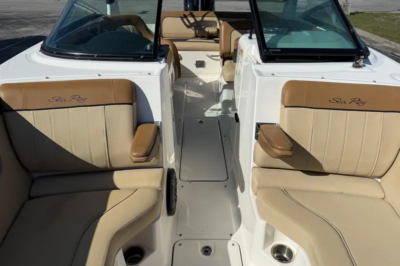Slide: The Image of 2014 Sea Ray 240 Sundeck Outboard interior with tan seating and open deck layout. - 13