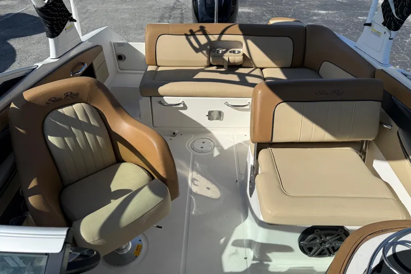Slide: The Image of 2014 Sea Ray 240 Sundeck Outboard interior with tan seating and cup holders. - 15
