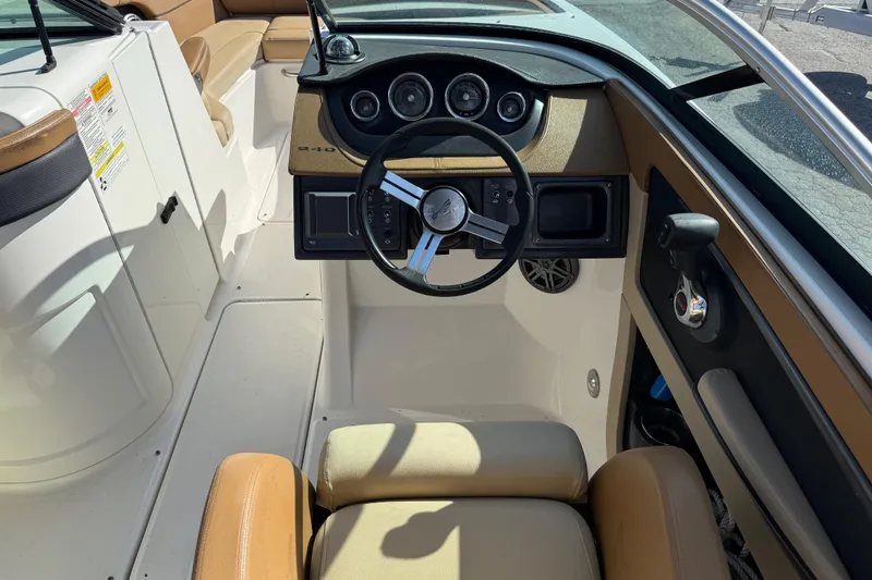 Slide: The Image of 2014 Sea Ray 240 Sundeck Outboard boat interior with steering wheel and dashboard. - 20