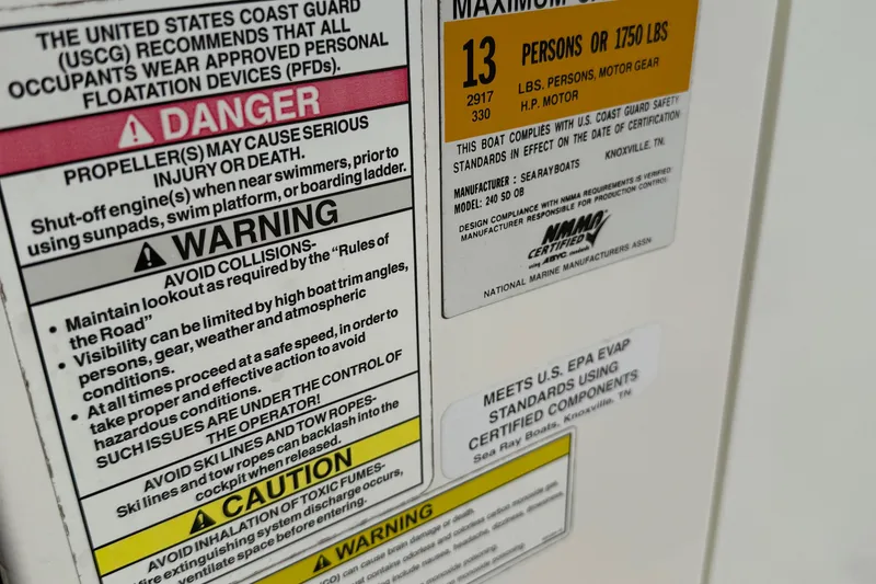 Slide: The Image of Safety warnings and capacity label on 2014 Sea Ray 240 Sundeck Outboard boat. - 25