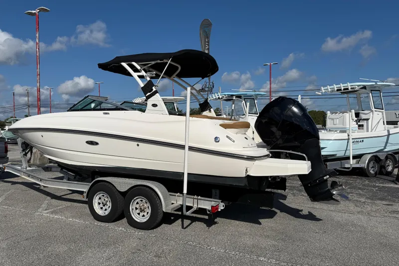 Slide: The Image of 2014 Sea Ray 240 Sundeck Outboard on trailer under clear blue sky. - 5