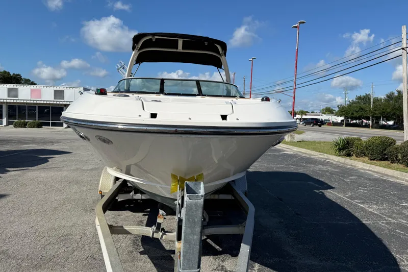 Slide: The Image of 2014 Sea Ray 240 Sundeck Outboard boat on trailer under clear blue sky. - 7