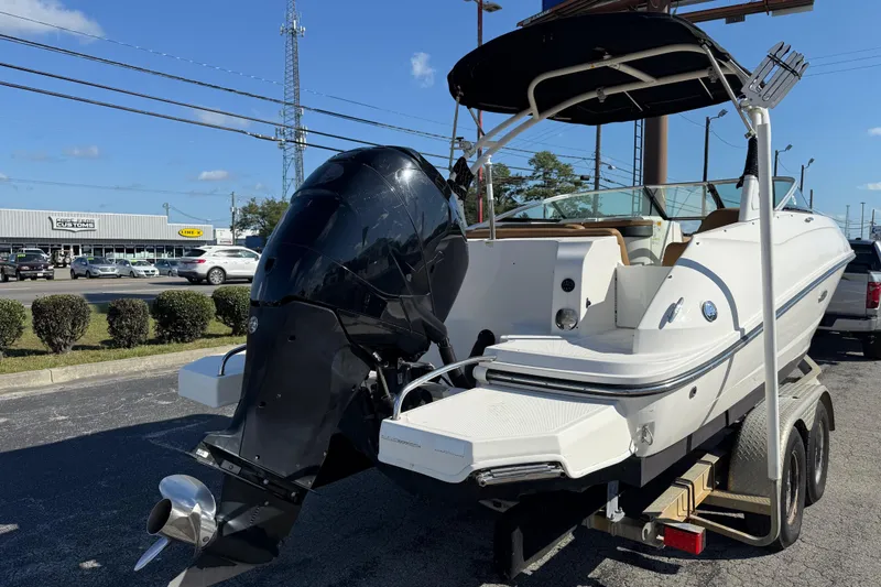 Slide: The Image of 2014 Sea Ray 240 Sundeck Outboard boat on trailer, parked outdoors. - 8