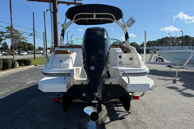 Slide: The Image of 2014 Sea Ray 240 Sundeck Outboard boat, rear view with outboard motor, parked outdoors. - 9