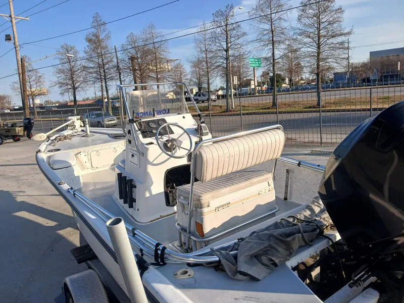 Slide: The Image of 2006 Kenner 21 boat on trailer in sunny parking lot. - 3