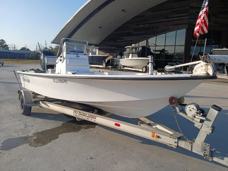 Slide: The Image of 2006 Kenner 21 boat console with steering wheel and navigation equipment. - 9