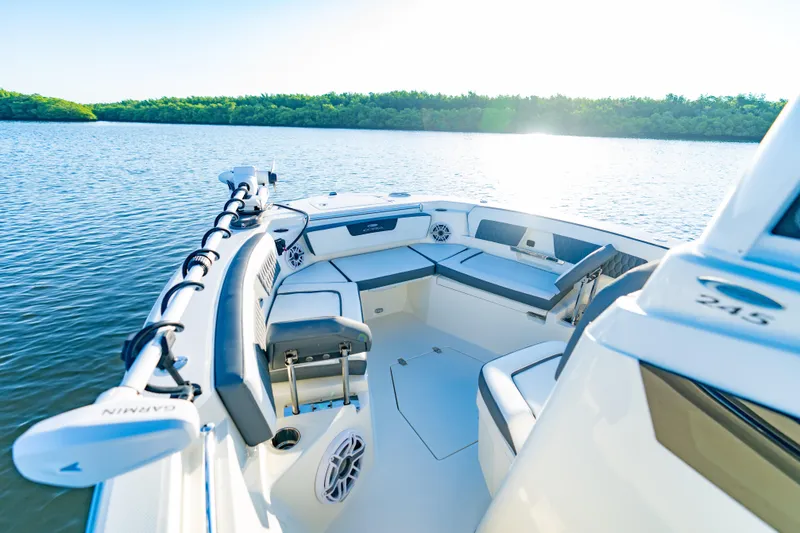 Slide: The Image of 2026 Cobia 245 Center Console boat on calm water, featuring spacious seating and modern design. - 13
