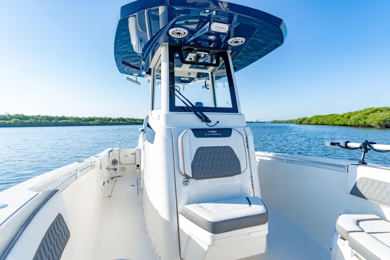Slide: The Image of 2026 Cobia 245 Center Console boat on calm water, featuring sleek design and modern amenities. - 14