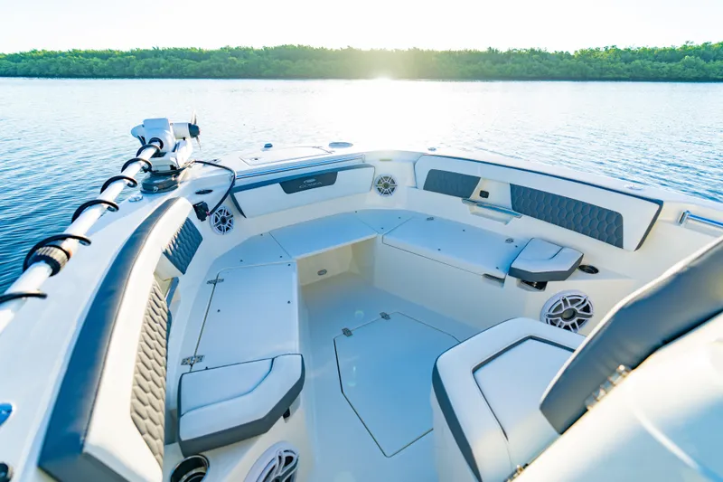 Slide: The Image of 2026 Cobia 245 Center Console boat interior on calm water at sunset. - 15
