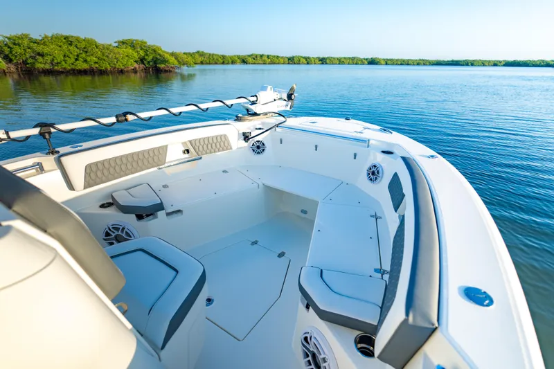 Slide: The Image of 2026 Cobia 245 Center Console boat on calm water, featuring spacious seating and modern design. - 16
