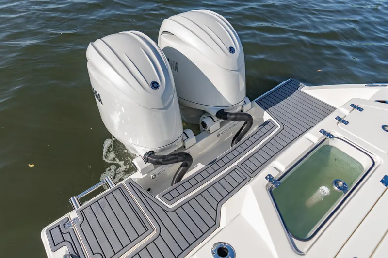 Slide: The Image of 2026 Cobia 245 Center Console with dual outboard engines on water. - 5