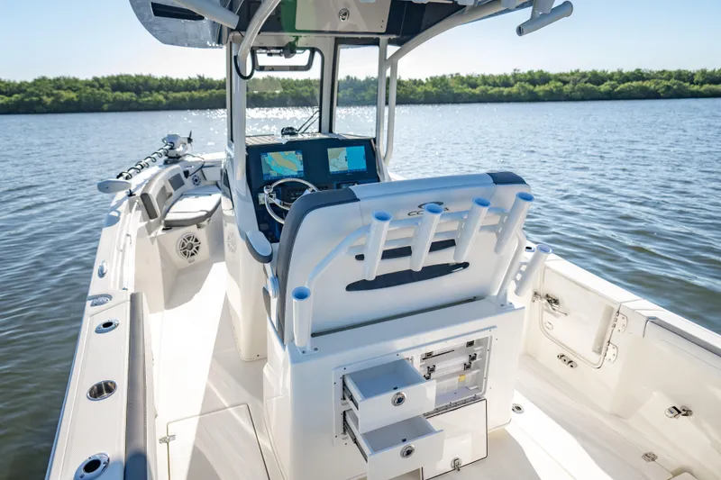 Slide: The Image of 2026 Cobia 245 Center Console boat on calm water, featuring advanced navigation systems. - 7