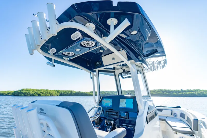 Slide: The Image of 2026 Cobia 245 Center Console boat interior with advanced navigation system on a sunny day. - 9