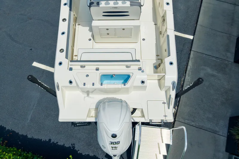 Slide: The Image of Overhead view of 2027 Cobia 245 Center Console boat with powerful outboard motor. - 10