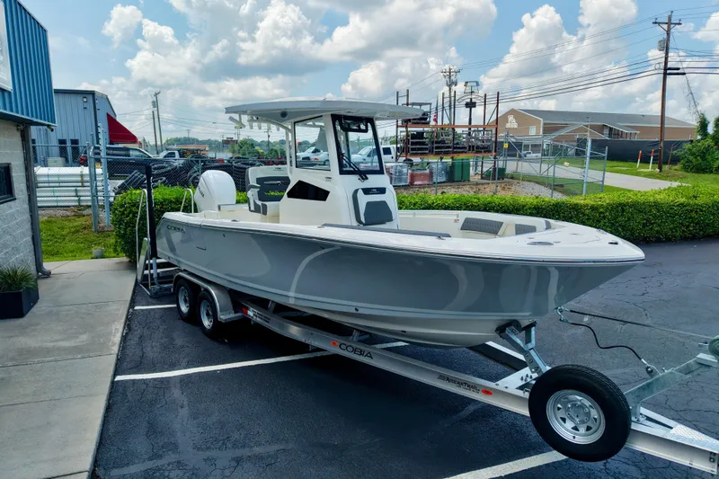 Slide: The Image of 2027 Cobia 245 Center Console boat on trailer in parking lot under cloudy sky. - 20