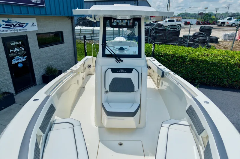 Slide: The Image of 2027 Cobia 245 Center Console boat at dealership, showcasing spacious deck and seating. - 15