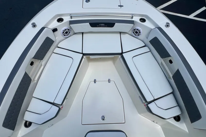 Slide: The Image of 2027 Cobia 245 Center Console boat interior with cushioned seating and speakers. - 16