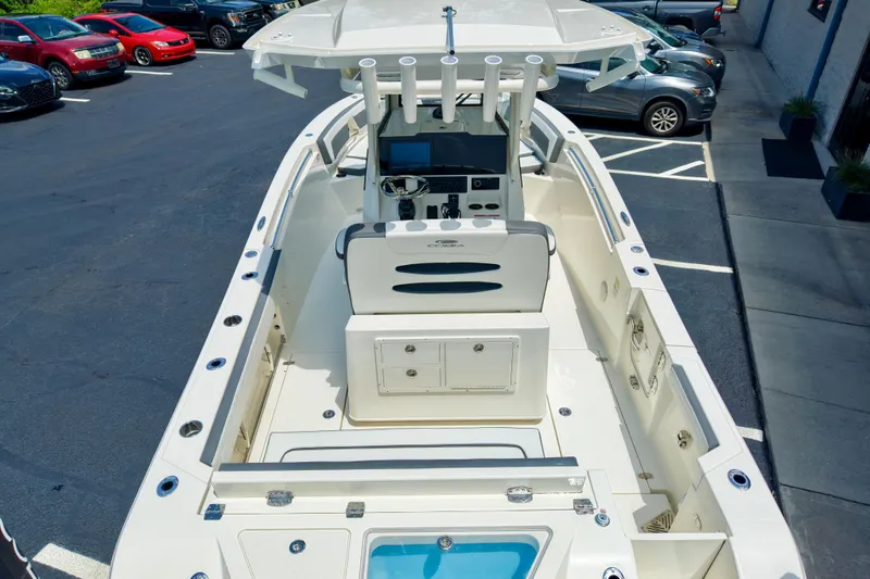 Slide: The Image of 2027 Cobia 245 Center Console boat with sleek design, parked in a lot. - 11