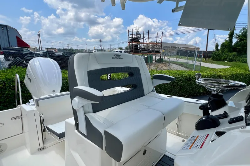 Slide: The Image of 2027 Cobia 245 Center Console boat with sleek seating and modern controls. - 13